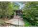 Charming front entrance featuring stone accents, a stylish blue door, and lush landscaping at 4832 Brookhaven Dr, Raleigh, NC 27612