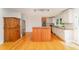 Well-lit kitchen features a center island, stainless steel appliances, and white cabinets at 4832 Brookhaven Dr, Raleigh, NC 27612