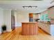 Bright kitchen with a center island, stainless steel appliances, and hardwood floors at 4832 Brookhaven Dr, Raleigh, NC 27612
