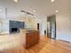 Open kitchen layout with a center island, stainless steel refrigerator, and hardwood floors at 4832 Brookhaven Dr, Raleigh, NC 27612