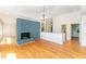 Bright living room with a blue fireplace, hardwood floors, and an open layout for easy entertaining at 4832 Brookhaven Dr, Raleigh, NC 27612