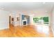 Spacious living room features hardwood floors, fireplace, blue accent wall, and large windows at 4832 Brookhaven Dr, Raleigh, NC 27612