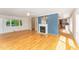 Open-concept living room with a fireplace, hardwood floors, and large windows for natural light at 4832 Brookhaven Dr, Raleigh, NC 27612