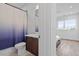 Modern bathroom with a toilet, vanity, and a partially visible bedroom space at 512 Gordon St # 1006, Durham, NC 27701