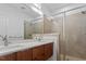 Modern bathroom with double sink vanity, quartz countertop, and a glass-enclosed shower at 512 Gordon St # 1006, Durham, NC 27701