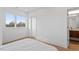 Bright bedroom showcasing a cozy bed, large windows, and access to an attached bathroom at 512 Gordon St # 1006, Durham, NC 27701