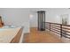 Bright bedroom featuring a unique glass elevator and sleek wood railing and flooring at 512 Gordon St # 1006, Durham, NC 27701