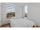 Bright bedroom featuring a white bed and large windows offering scenic views at 512 Gordon St # 1006, Durham, NC 27701
