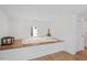A cozy bedroom nook with wood platform bed, small window, and a nearby door at 512 Gordon St # 1006, Durham, NC 27701