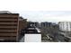 A rooftop patio with a wooden privacy screen and a distant view of the city skyline at 512 Gordon St # 1006, Durham, NC 27701