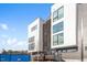 Modern townhomes with large windows and a combination of white and gray siding under a bright, blue sky at 512 Gordon St # 1006, Durham, NC 27701