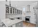 An open kitchen featuring stainless steel appliances, grey cabinets, quartz countertops and hardwood floors at 512 Gordon St # 1006, Durham, NC 27701