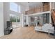 Open floorplan living room featuring a residential elevator, hardwood floors, a modern kitchen and staircase at 512 Gordon St # 1006, Durham, NC 27701