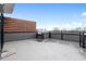 View of a spacious rooftop patio with gray flooring and a wooden privacy screen at 512 Gordon St # 1006, Durham, NC 27701