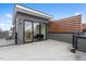 Rooftop patio featuring gray siding and a partial wooden privacy screen, ideal for outdoor living at 512 Gordon St # 1006, Durham, NC 27701