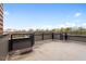 Spacious rooftop patio with gray flooring and metal railings offering ample outdoor living space at 512 Gordon St # 1006, Durham, NC 27701