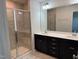 Bathroom features a tiled shower with glass doors, double sink vanity, and large mirror at 5122 Jessip St, Morrisville, NC 27560