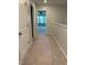 Upstairs hallway with carpet, multiple doors and entryways, and neutral paint at 5122 Jessip St, Morrisville, NC 27560
