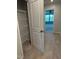 Hallway leads to bedroom with natural lighting and includes a spacious shelving unit at 5122 Jessip St, Morrisville, NC 27560