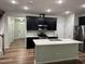 Modern kitchen featuring stainless steel appliances, a center island, and sleek black cabinetry at 5122 Jessip St, Morrisville, NC 27560