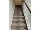 Carpeted staircase with white railing leads to the upper level of the home at 5122 Jessip St, Morrisville, NC 27560