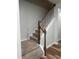 Carpeted staircase with white railing and stained wood trim leads to the next level of the home at 5122 Jessip St, Morrisville, NC 27560