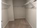 Walk-in closet with white wire shelving and carpeted floor at 5122 Jessip St, Morrisville, NC 27560