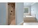 Bathroom showcasing a shower and bathtub area with neutral-colored tile and fixtures at 5217 Roswellcrest Ct, Apex, NC 27539