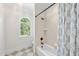 Bright bathroom features a tub, shower, and arched window allowing natural light at 5217 Roswellcrest Ct, Apex, NC 27539