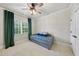 Cozy bedroom featuring a daybed with floral patterns, neutral walls, and plush carpeting at 5217 Roswellcrest Ct, Apex, NC 27539