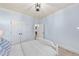 A bedroom with light blue walls, a full bed, and an entrance to another area of the home at 5217 Roswellcrest Ct, Apex, NC 27539