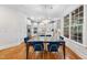 Dining area featuring hardwood floors, modern lighting, and a large window with natural light at 5217 Roswellcrest Ct, Apex, NC 27539