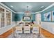Stylish dining room featuring a modern chandelier, neutral color palette, and wainscoting at 5217 Roswellcrest Ct, Apex, NC 27539