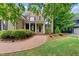 Attractive brick home featuring manicured landscaping, a circular brick walkway, and a welcoming front entrance at 5217 Roswellcrest Ct, Apex, NC 27539