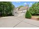 Spacious three-car garage offering ample parking and storage space, surrounded by lush landscaping at 5217 Roswellcrest Ct, Apex, NC 27539
