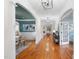 Elegant hallway with hardwood floors, decorative archways, and views into the dining and living areas at 5217 Roswellcrest Ct, Apex, NC 27539