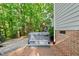 Backyard featuring a hot tub set on a brick paver patio with wooden steps and brick siding at 5217 Roswellcrest Ct, Apex, NC 27539