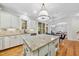 Modern kitchen with a granite island, stainless steel appliances, and access to the dining area at 5217 Roswellcrest Ct, Apex, NC 27539