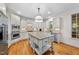 Well-appointed kitchen with stainless appliances, custom cabinetry, and a granite-topped island at 5217 Roswellcrest Ct, Apex, NC 27539