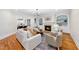 Open concept living room with built-in bookshelves, elegant fireplace, and hardwood flooring at 5217 Roswellcrest Ct, Apex, NC 27539