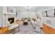 Elegant living room with a fireplace, built-in bookshelves, and a seamless open layout at 5217 Roswellcrest Ct, Apex, NC 27539