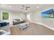 Bright living room with neutral sofas, a wooden table, carpet, and double doors at 5217 Roswellcrest Ct, Apex, NC 27539