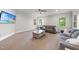 Expansive living room features neutral decor, sofas, carpet, and multiple windows at 5217 Roswellcrest Ct, Apex, NC 27539