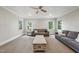 Spacious living room with modern sofas, a wooden coffee table, carpet, and natural light at 5217 Roswellcrest Ct, Apex, NC 27539