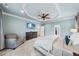 Spacious bedroom featuring a ceiling fan, TV, sitting area, and recessed lighting at 5217 Roswellcrest Ct, Apex, NC 27539