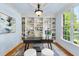 Comfortable home office featuring custom built-ins, ample natural light, and a modern desk setup at 5217 Roswellcrest Ct, Apex, NC 27539