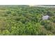 Lush green aerial view of a neighborhood with a pond and plentiful trees at 5241 Mill Dam Rd, Wake Forest, NC 27587