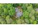 Aerial shot of a home with a backyard patio nestled amongst mature trees at 5241 Mill Dam Rd, Wake Forest, NC 27587