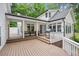 Expansive back deck with a grill, bar seating, and plenty of space for entertaining at 5241 Mill Dam Rd, Wake Forest, NC 27587