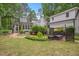 Spacious backyard with mature landscaping, a hot tub, and an outdoor seating area at 5241 Mill Dam Rd, Wake Forest, NC 27587